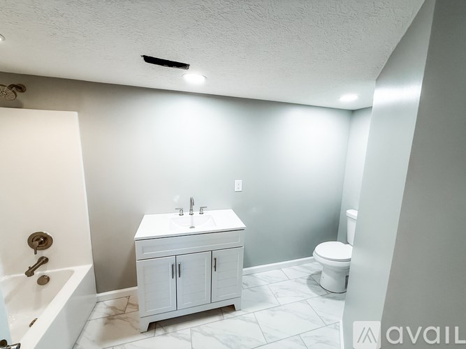 A bathroom with a toilet and a sink.