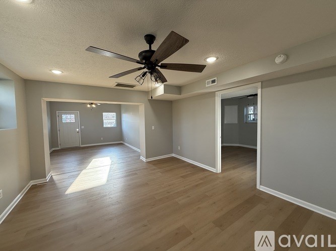 A white bathroom with a sink and a door.