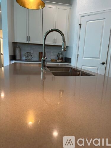 A kitchen with a sink and a countertop.