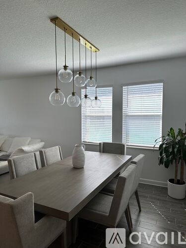 A dining room with a wooden table and chairs.