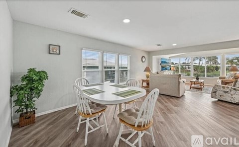 A living room with a dining table and chairs.
