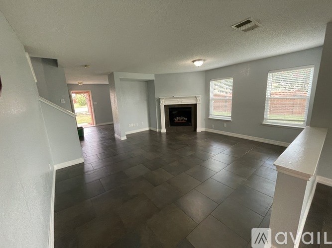 A living room with a fireplace and a television.