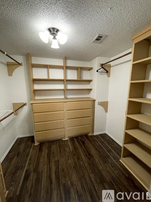 A room with wooden shelves and a white ceiling.