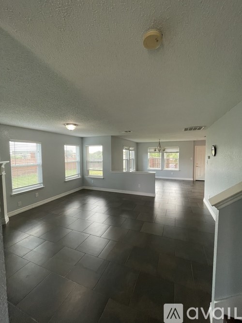 A room with a tiled floor and a window.