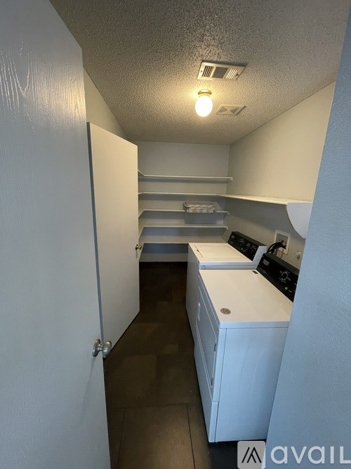 A small laundry room with a washer and dryer.