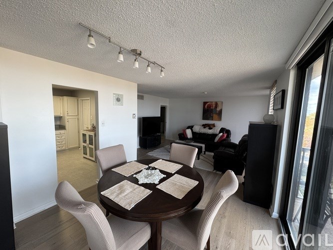 A dining room with a table set for four.