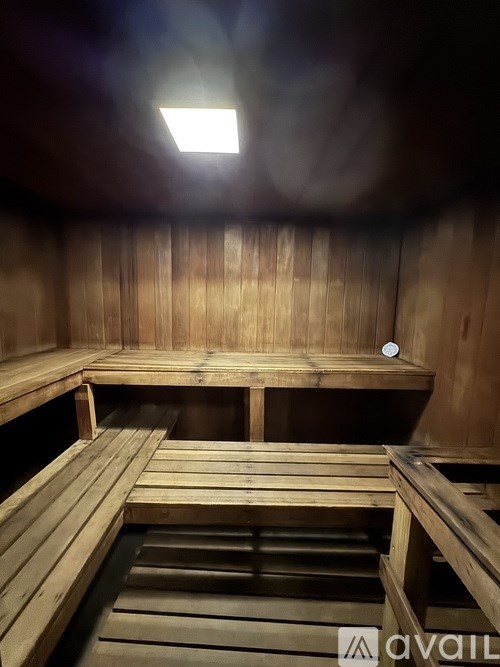 A sauna with wooden benches and a light on the ceiling.