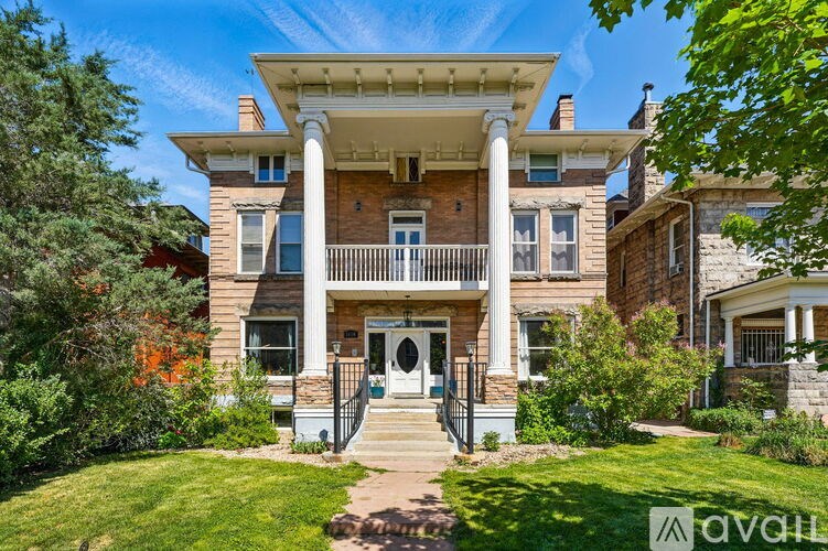 A large house with a front porch and a balcony.