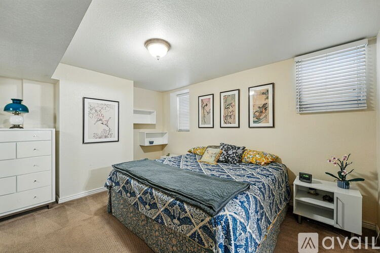A bedroom with a bed, dresser, and nightstand.