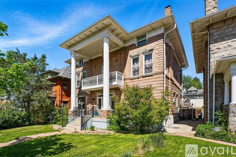 A house with a porch and a balcony is for sale.