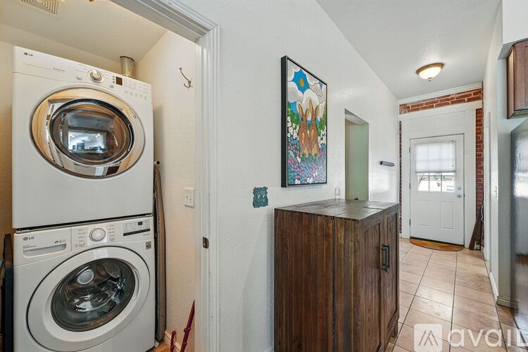 A laundry room with a washer and dryer stacked on top of each other.