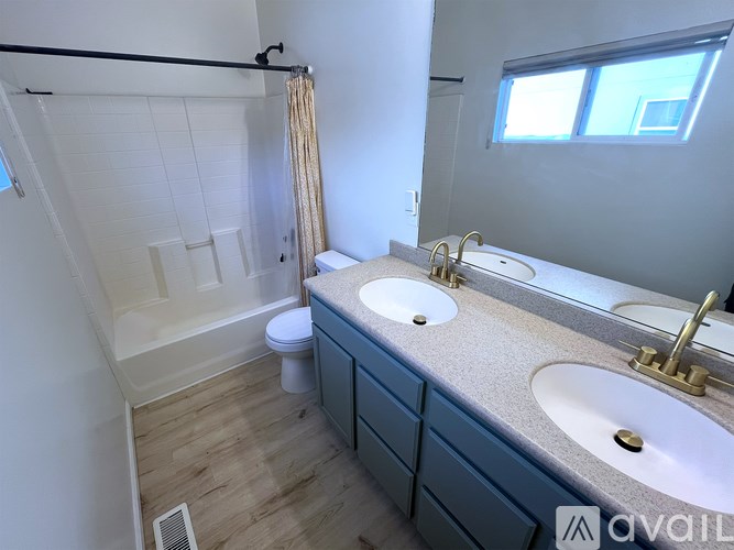 A bathroom with a toilet, sink, and shower.