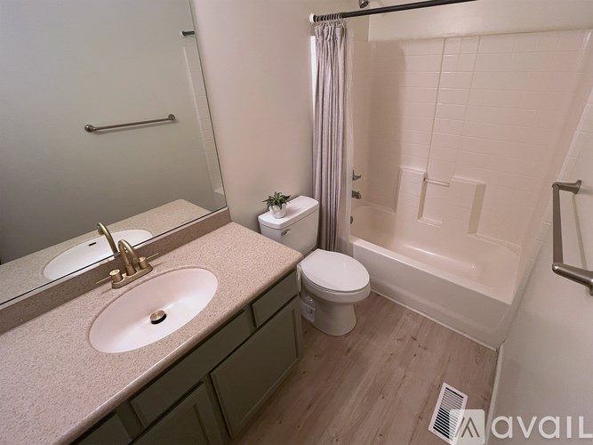 A bathroom with a sink, toilet, and bathtub.