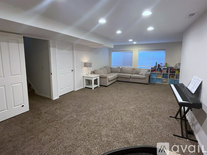 A living room with a piano and a couch.