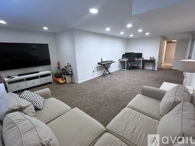 A living room with a grey sofa and a television.