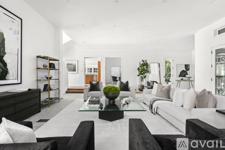 A modern living room with a black and white color scheme.
