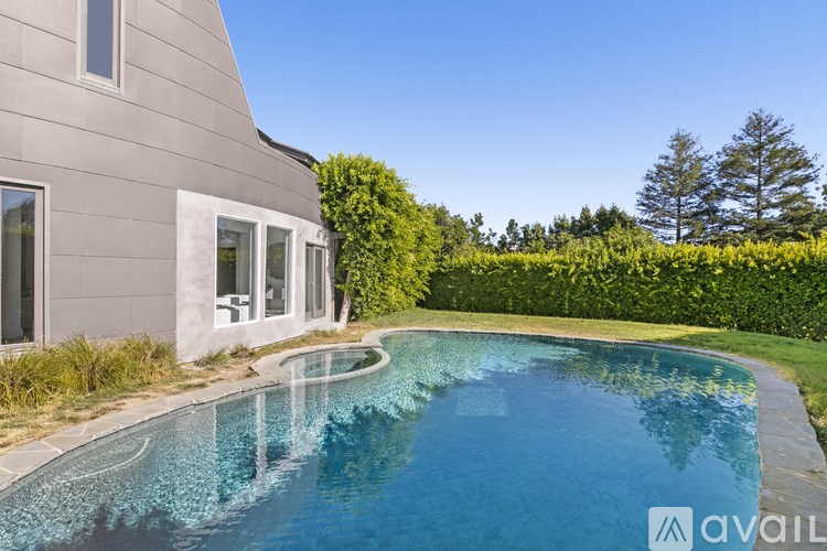 A modern house with a swimming pool in the backyard.