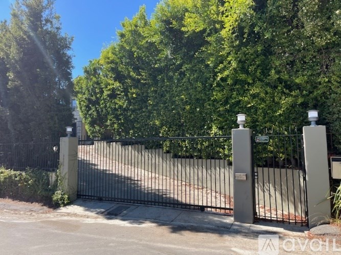 A black metal gate with two pillars on either side.