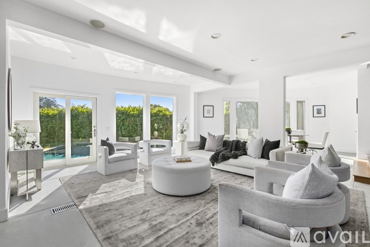 A modern living room with a grey sofa and a round coffee table.