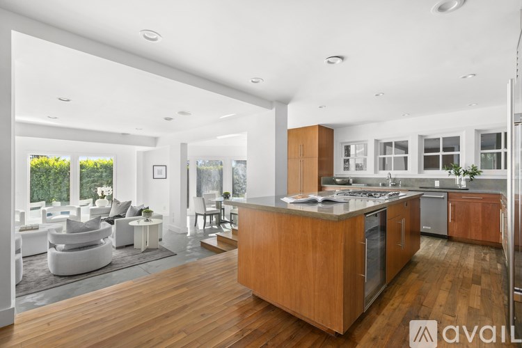 A modern kitchen with wooden cabinets and a central island.