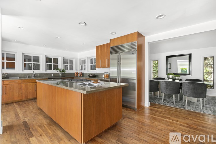 A modern kitchen with wooden cabinets and a central island.