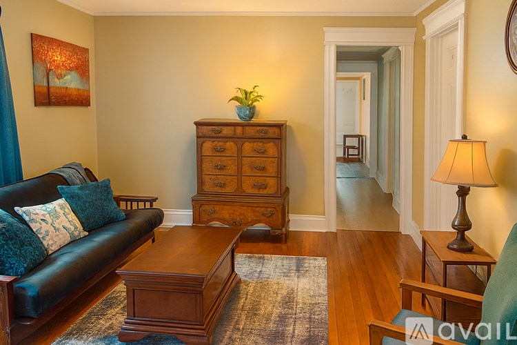 A living room with a blue couch and a wooden coffee table.