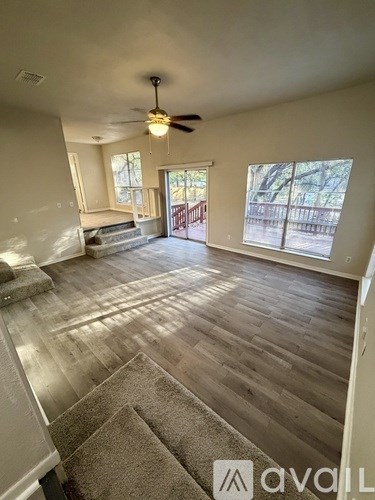A living room with a staircase leading to a balcony.