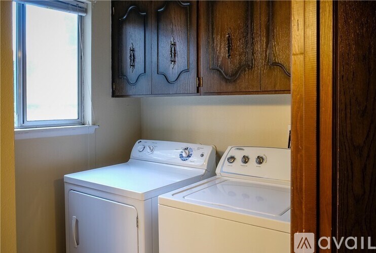 A washer and dryer are sitting next to each other in a small laundry room.
