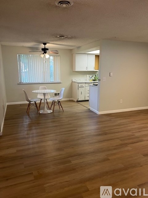 A kitchen with a table and chairs in the middle of the room.