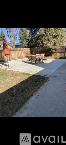 A patio with a table and chairs is visible.