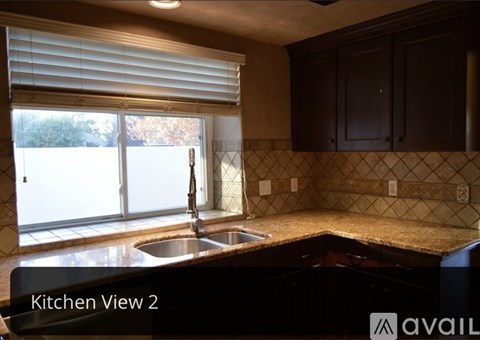 A kitchen with brown cabinets and a tiled backsplash.