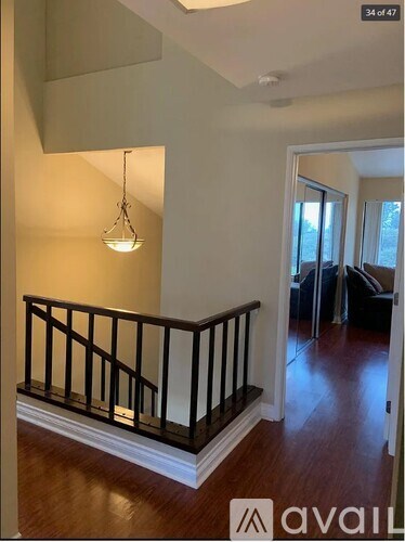 A living room with a couch and a chandelier.