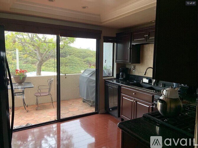 A kitchen with a table and chairs outside.