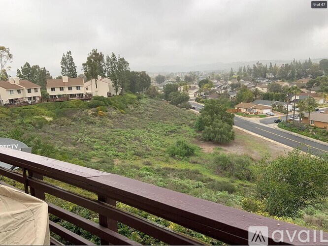A view from a balcony overlooking a residential area.