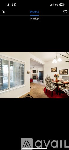 A room with a dining table and chairs.