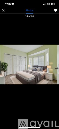 A bedroom with a bed, nightstand, and lamp.