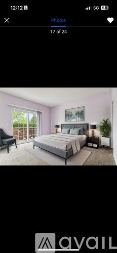 A bedroom with a large bed and a balcony.