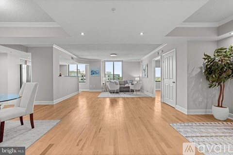 A spacious living room with a dining table and chairs.
