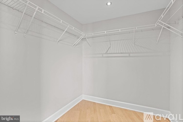 Empty room with white walls and wooden floor.