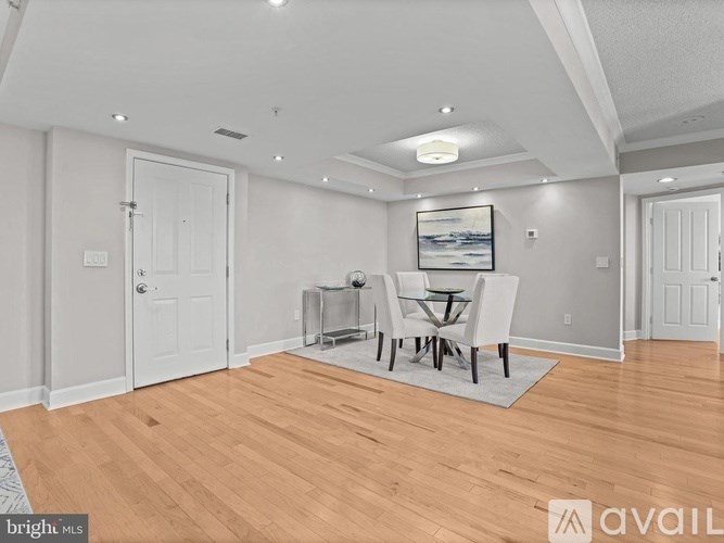 A spacious room with a dining table and chairs.