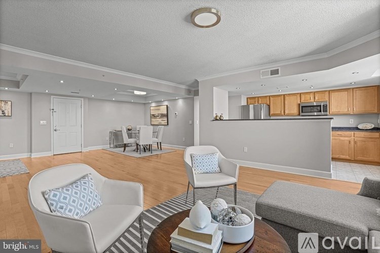 A living room with a grey sofa, a white chair and a coffee table.