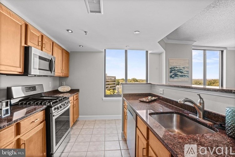 A kitchen with wooden cabinets and a stainless steel sink.