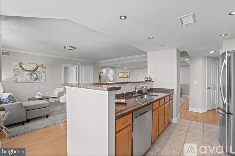 A modern kitchen with wooden cabinets and a central island.