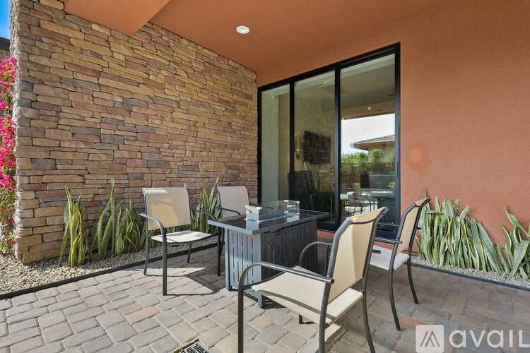 A patio with a table and chairs is shown.