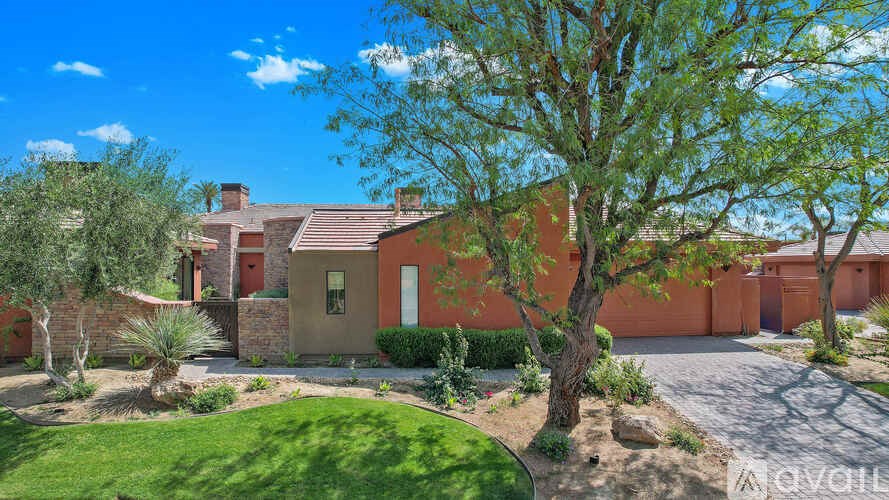 A house with a red roof and a tree in front of it.