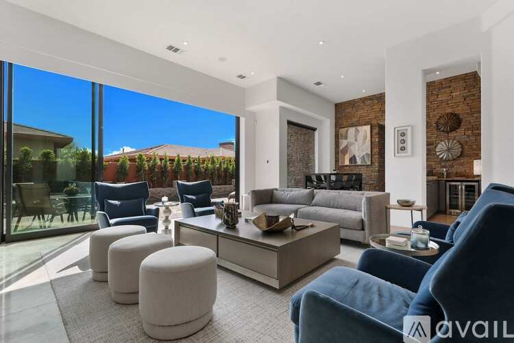 A modern living room with a glass door leading to a garden.