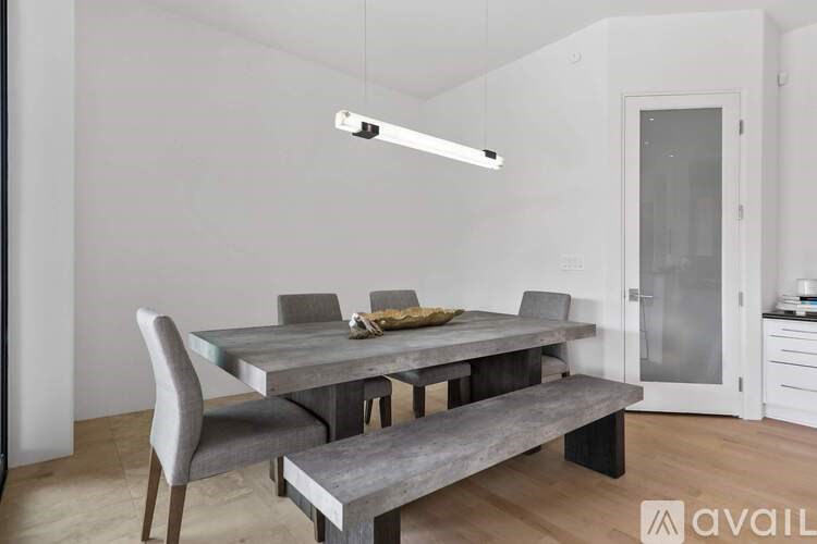A modern dining room with a table and chairs.