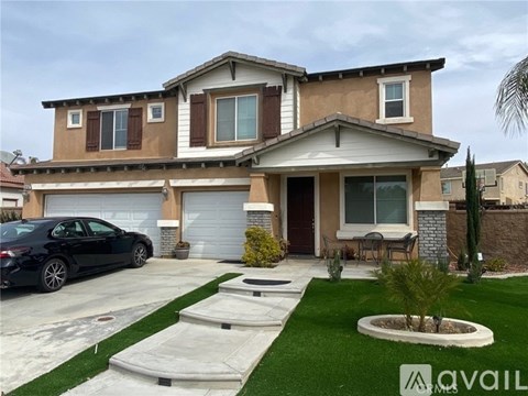 A house with a black car parked in front.