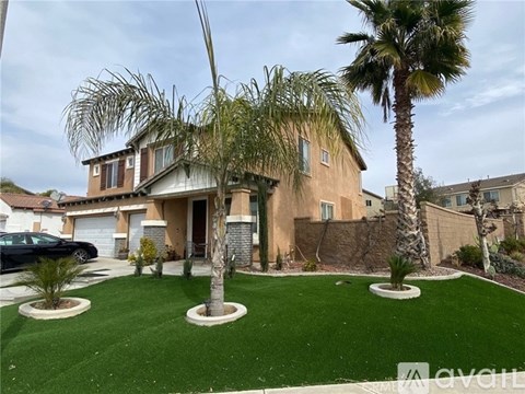 A house with a palm tree in front of it.