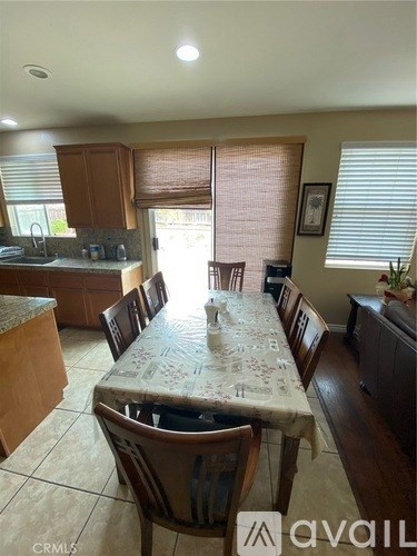 A kitchen with a table and chairs in the middle of the room.
